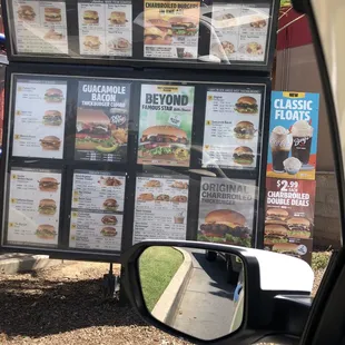 a menu board in the rear view mirror