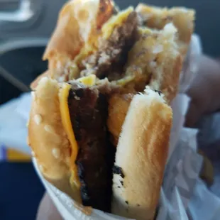 a hand holding a sandwich