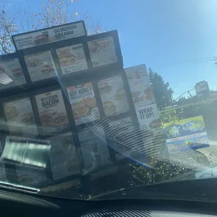 a bunch of pizza boxes on the windshield of a car