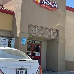 a car parked in front of a restaurant