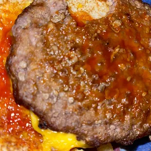 a hamburger with cheese and tomato sauce