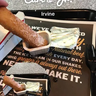 a person dipping a donut into a container