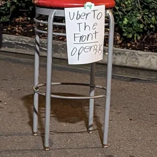 a stool with a sign on it