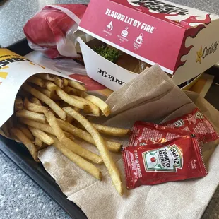 a tray of fries and a bag of chips