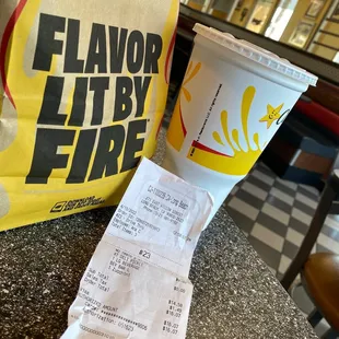 a cup of coffee and a receipt