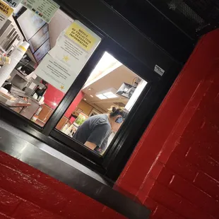 a man in the window of a restaurant