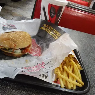 a hamburger and fries on a tray