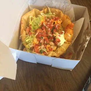 Chicken taco salad. Looks like a box they use at bakeries for small cakes.