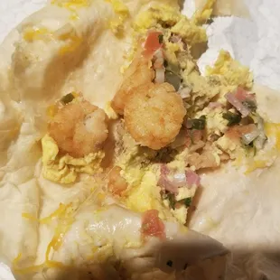 a burrito with shrimp and rice