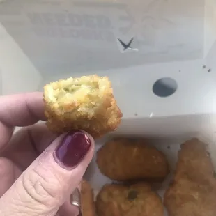 a hand holding a piece of food