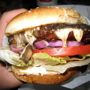 a hand holding a hamburger