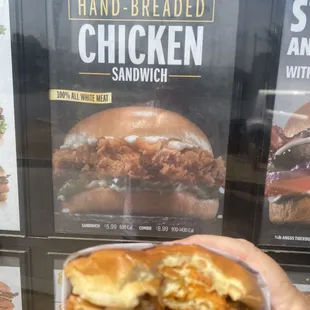 a hand holding a sandwich