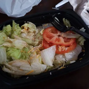 Their version of a side salad. Quarter of a head of lettuce and two slices of tomato. It's  their burger ingredients and threw it in a bowl.