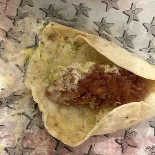 a burrito with meat and sauce