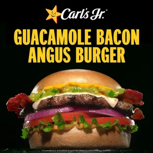 a large hamburger with bacon, lettuce, tomato, and onions