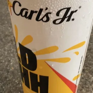 a paper cup with a drink in it