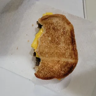 a half eaten sandwich on a napkin