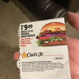 a hand holding a coup card