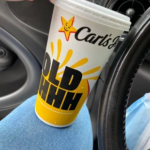 a hand holding a cup of coffee