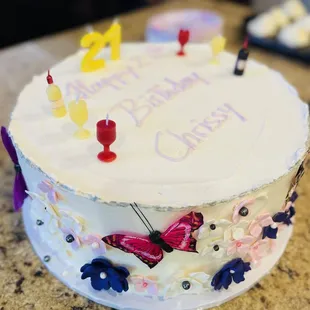 a birthday cake decorated with butterflies