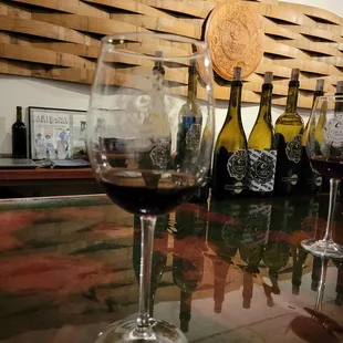 a glass of wine on a bar