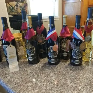 a row of wine bottles with flags on them