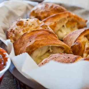 a basket of croissants and sauce