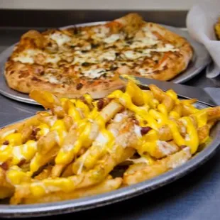 a plate of fries and a pizza
