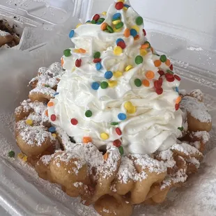 Birthday Cake Funnel Cake! Had icing melted into the warm crispy funnel cake, powder sugar, whipped cream and sprinkles!