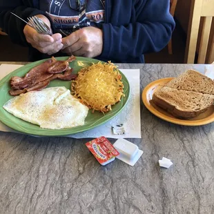 Two eggs, bacon, home fries and rye toast
