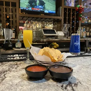 Seat @ the bar with a mimosa, chips, salsa, and bean dip