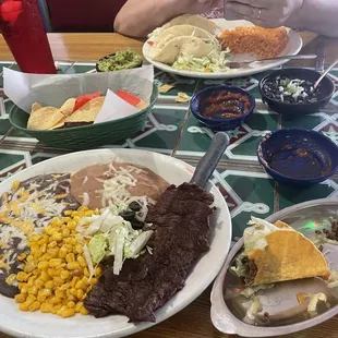 Combo platter -carne asada, chicken taco, cheese enchilada, refried beans, corn