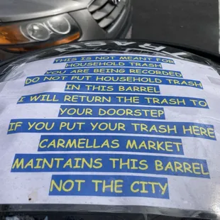 Carmella&apos;s garbage can sign