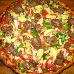 a meat and vegetable pizza