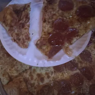 Photos of half cheese half pepperoni pizza pie  Extreme slice size difference