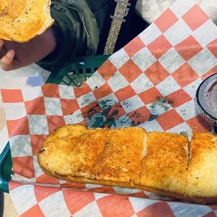 a person holding a sandwich