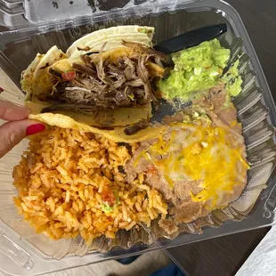 Beef taco, rice, beans, guacamole.