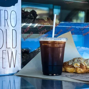 House nitro cold brew and almond croissant