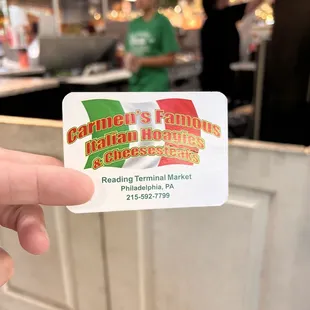 a hand holding a business card