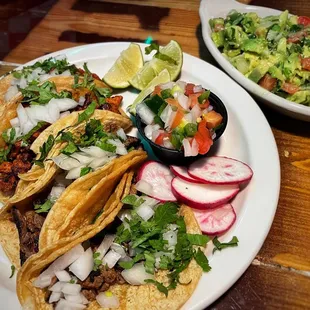 Carne asada and al pastor street tacos, guacamole casero.