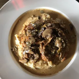 Chicken Marsala on top of mashed potatoes with a delicious variety of mushrooms ( not just the cheap buttons)