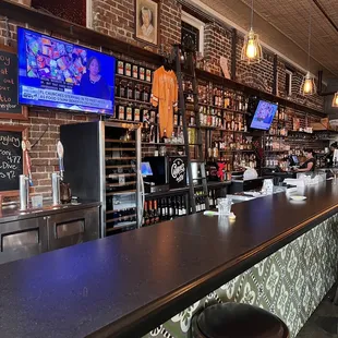 a bar with a television and bar stools