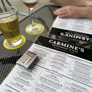 a glass of beer and a menu