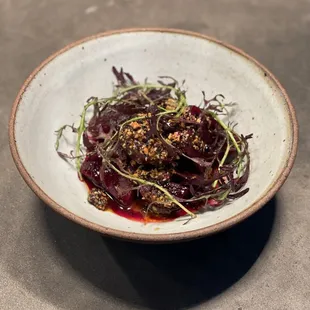 Braised beets with salsa macha, black garlic, and cured pork far