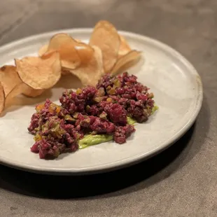 Hanger steak tartare with olive, apricot, mustard green aioli, and beef fat fried potato chips