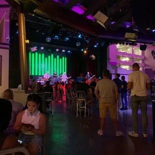 a crowd of people sitting and standing