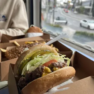 1/2 Lb . Cheeseburger Chili Fries Double Burger in the background