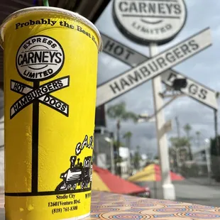 Inside with a super drink and outside sign