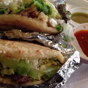 Carnita Gordita and Barbocoa Gordita with red and green chili sauces.
