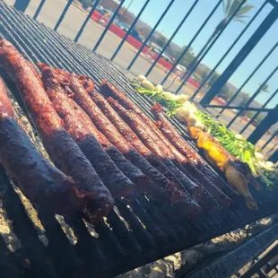 a grill with meat and vegetables on it